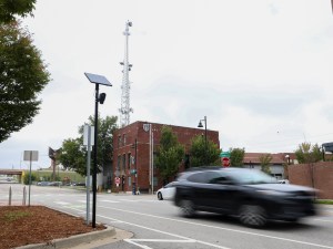 A car drives past a Flock Safety camera located along MLK Jr. Boulevard at the northeast corner of Guthrie Green on Oct. 27, 2025.