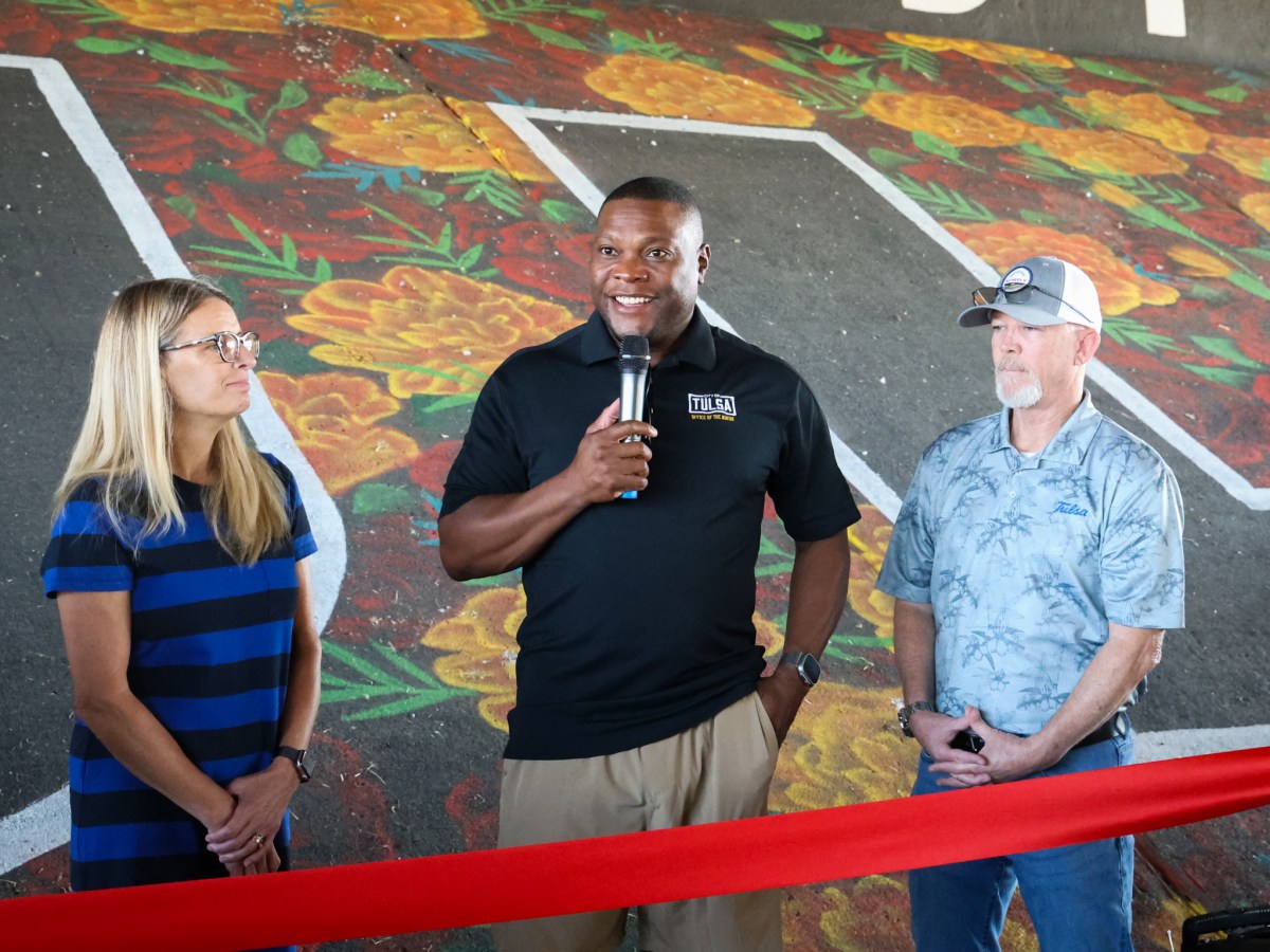 Mayor Monroe Nichols holding a microphone with City Councilors Karen Gilbert and Christian Bengel