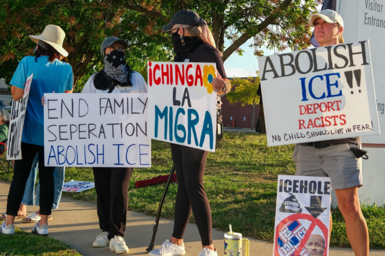 Tulsa residents wave signs in protest of the Tulsa County Sheriff’s cooperation with U.S. Immigration and Customs Enforcement, or ICE, in rounding up unauthorized migrants in Oklahoma on Oct. 8, 2025, in front of the David L. Moss Criminal Justice Center in Tulsa, Oklahoma.