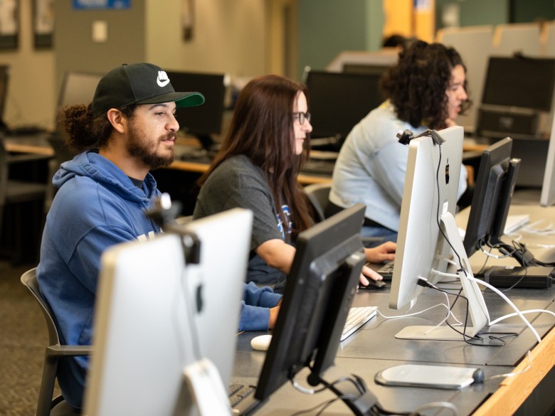 Students sitting in front of desktop computers