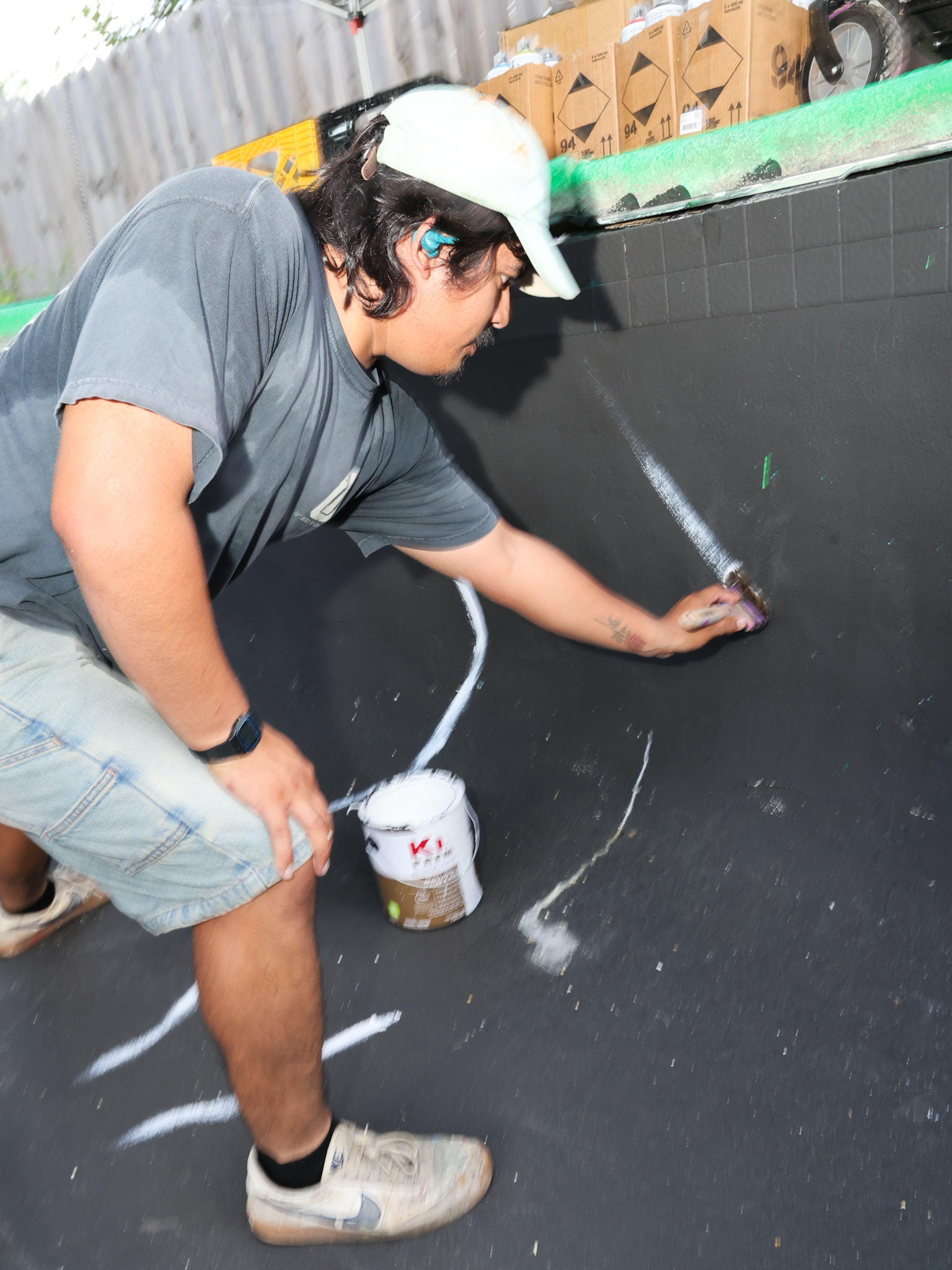 VNICE World, pictured painting a mural inside a pool in July, has drawn commissions from the Tulsa Global District and the city of Tulsa as well as businesses like Soundpony and Eiffel Tower Grilled Cheese Co.
