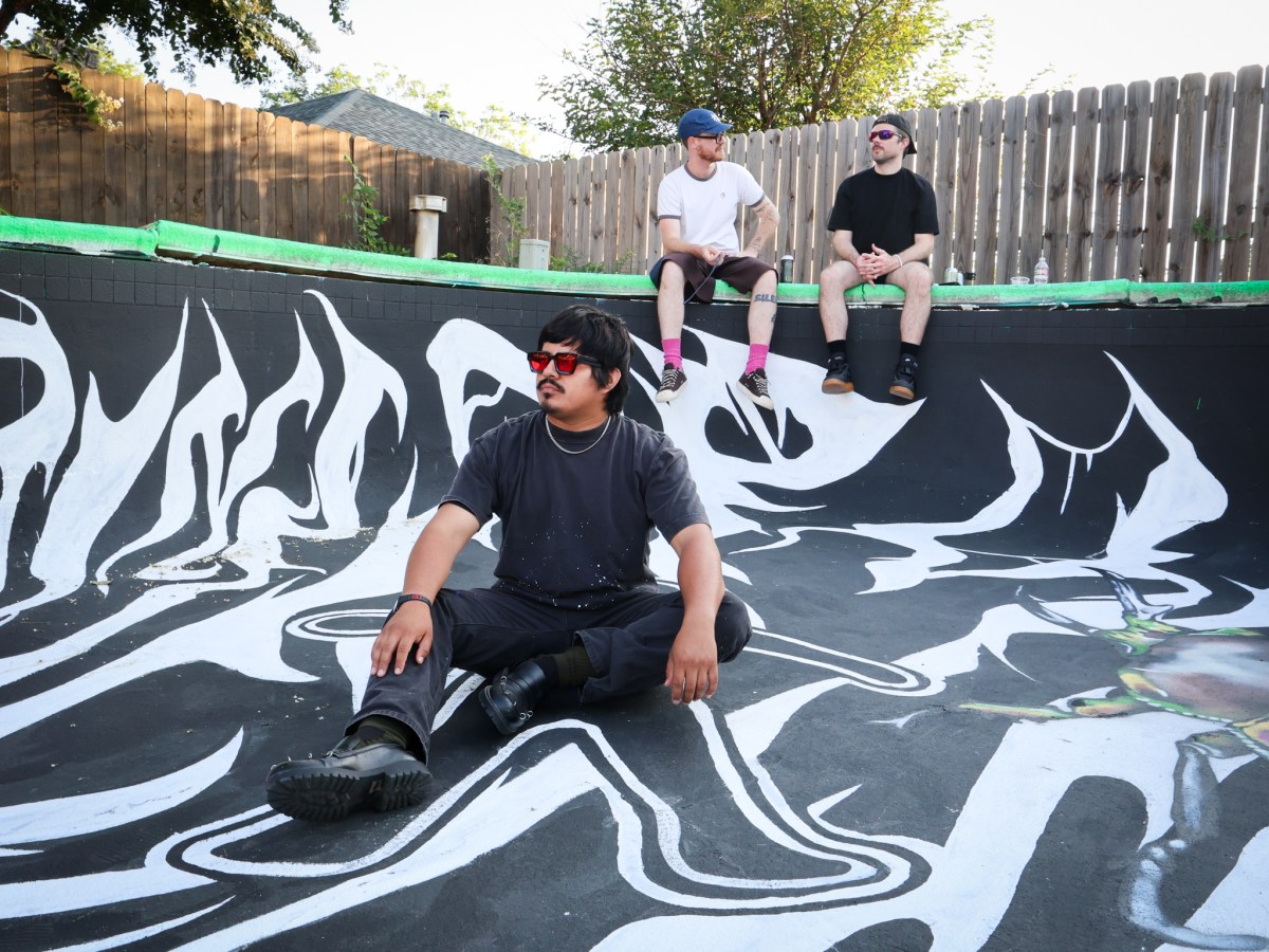 VNICE poses with his pool mural he created.