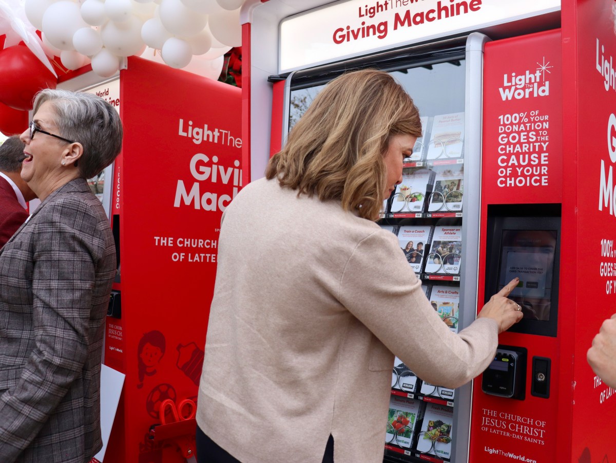 Photo of State. Rep. Suzanne Schreiber making a donation using the Tulsa Giving Machine