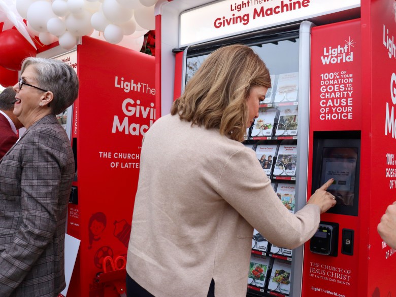 Photo of State. Rep. Suzanne Schreiber making a donation using the Tulsa Giving Machine