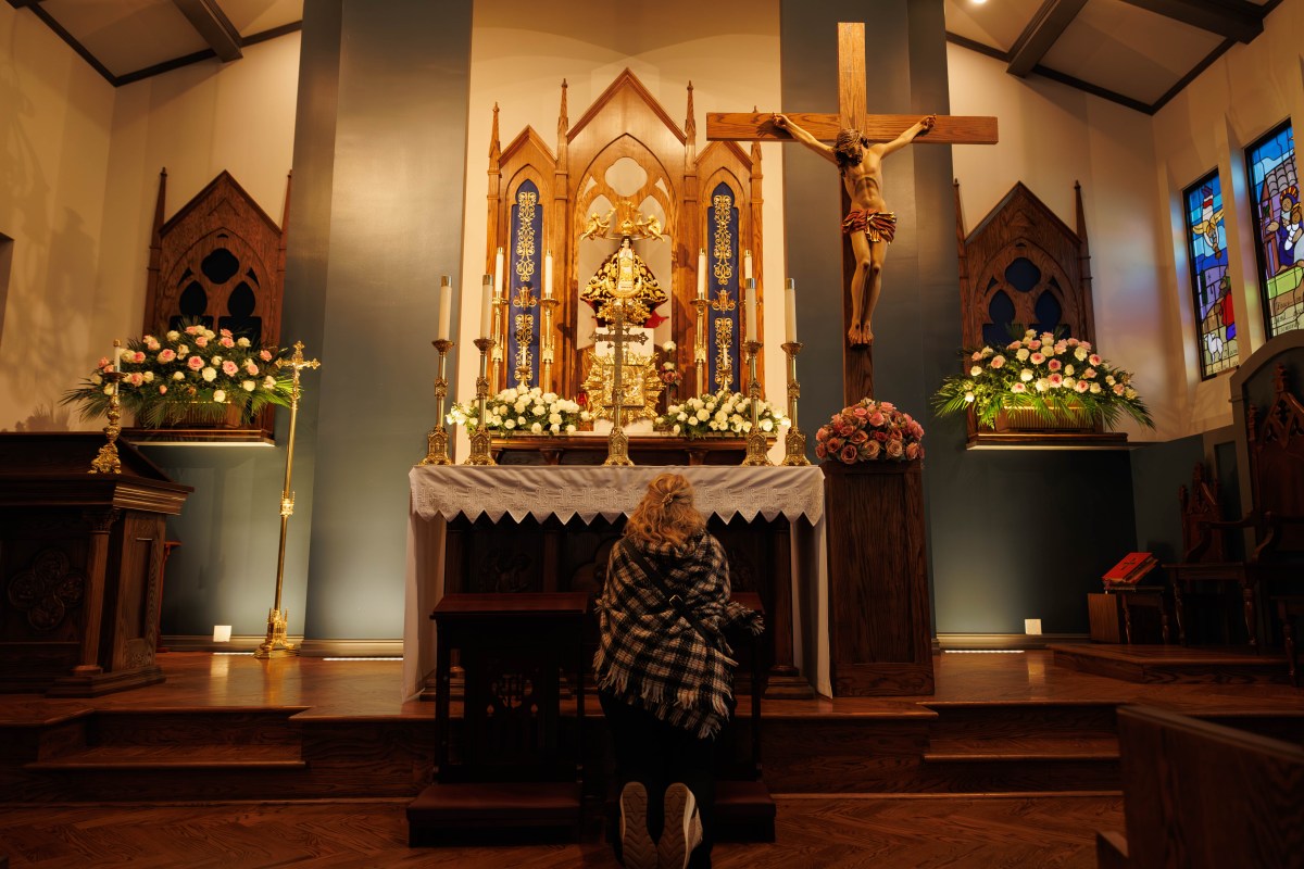 Photo of Leticia Arrieta Gonzalez kneeling in front of the new Shrine of Our Lady of San Juan de los Lagos