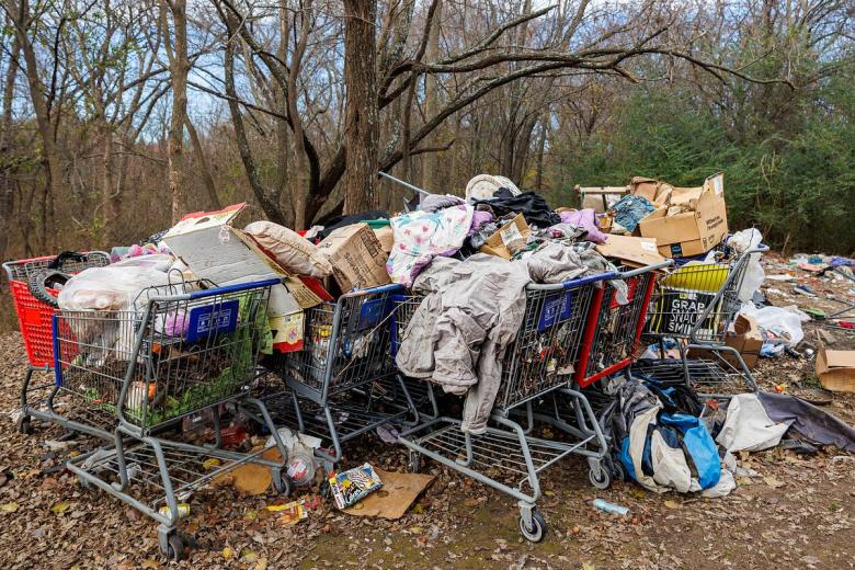 Trash and waste left behind at a homeless encampment located behind Lowes and Staples at 71st & US 169 on Dec. 18, 2025 in Tulsa.
