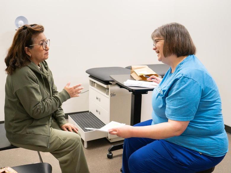 Registered nurse Rebecca Jaeger, right, talks with a patient at a Good Samaritan Health Services walk-in clinic on Dec. 16, 2025.
