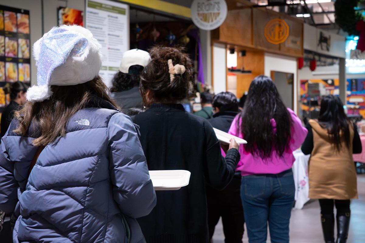 Guests walk through Mother Road Market during an event on Dec. 15, 2025.