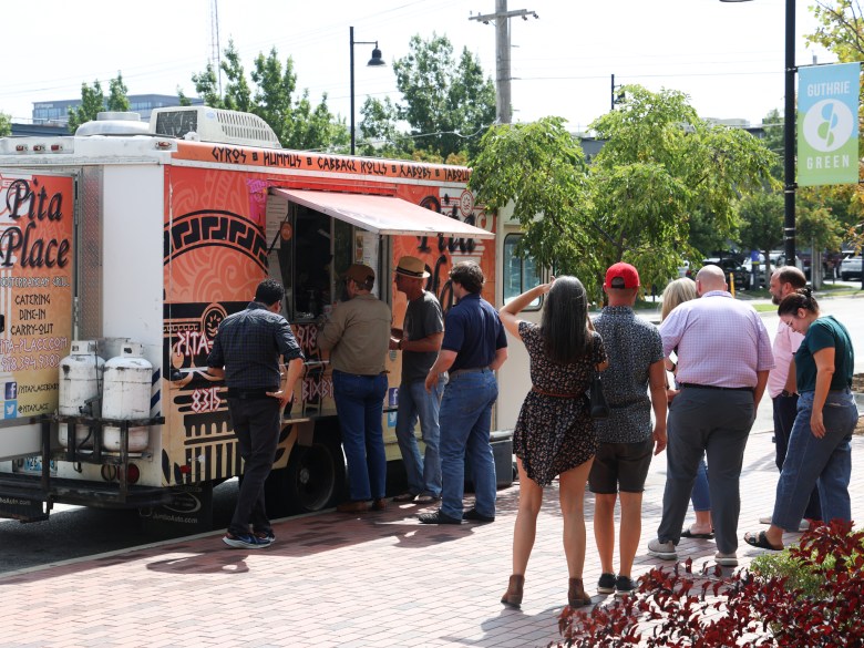 Photo of patrons in line at a food truck