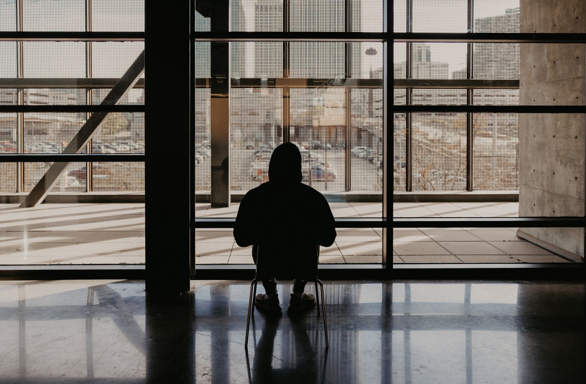 Man sitting looking at window