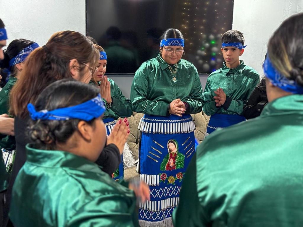 Danza Santa Maria prays the Hail Mary before heading to their first performance on Dec. 11. Danza is a form of prayer for each of them.