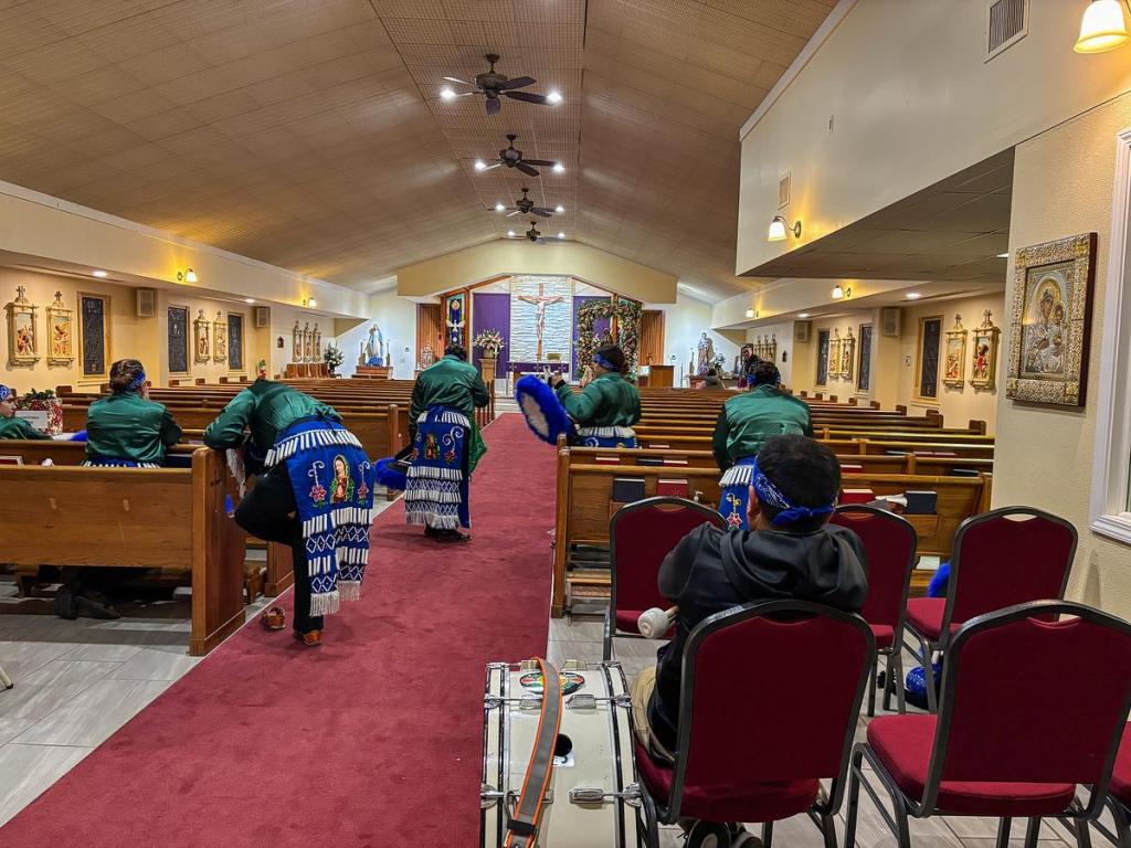 The group sits and waits to perform at St. Clement’s Catholic Church Dec. 11. Many felt nervous, while others were confident and excited.