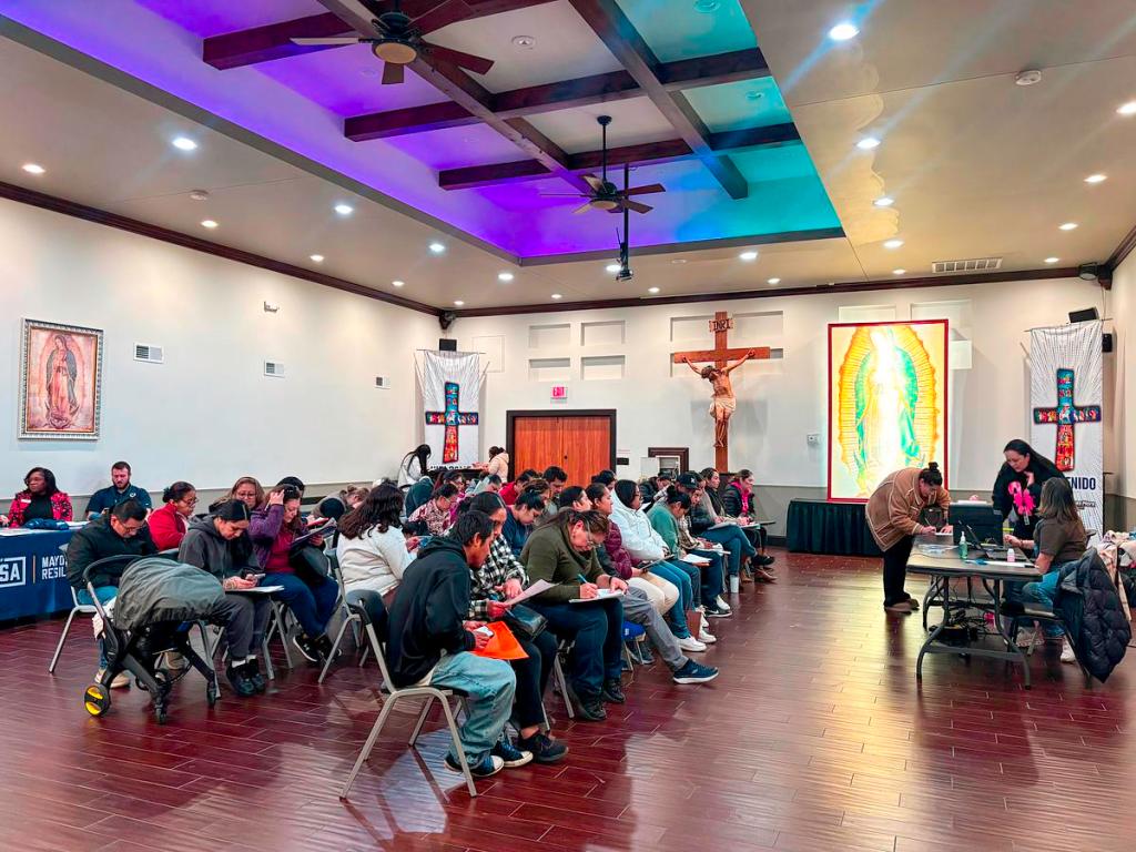 People fill out applications for dual citizenship and wait to speak with staff from the Mexican consulate in Oklahoma City on Dec. 10, 2025, at St. Thomas More Catholic Church in Tulsa.