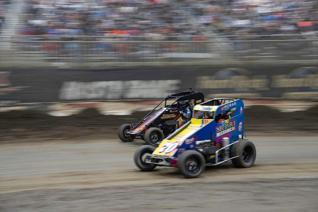 Two cars go into Turn 3 during a qualifying heat at the 2026 Chili Bowl Nationals Jan. 14, 2026.  The event draws vendors and racing fans from around the country for a full week. 