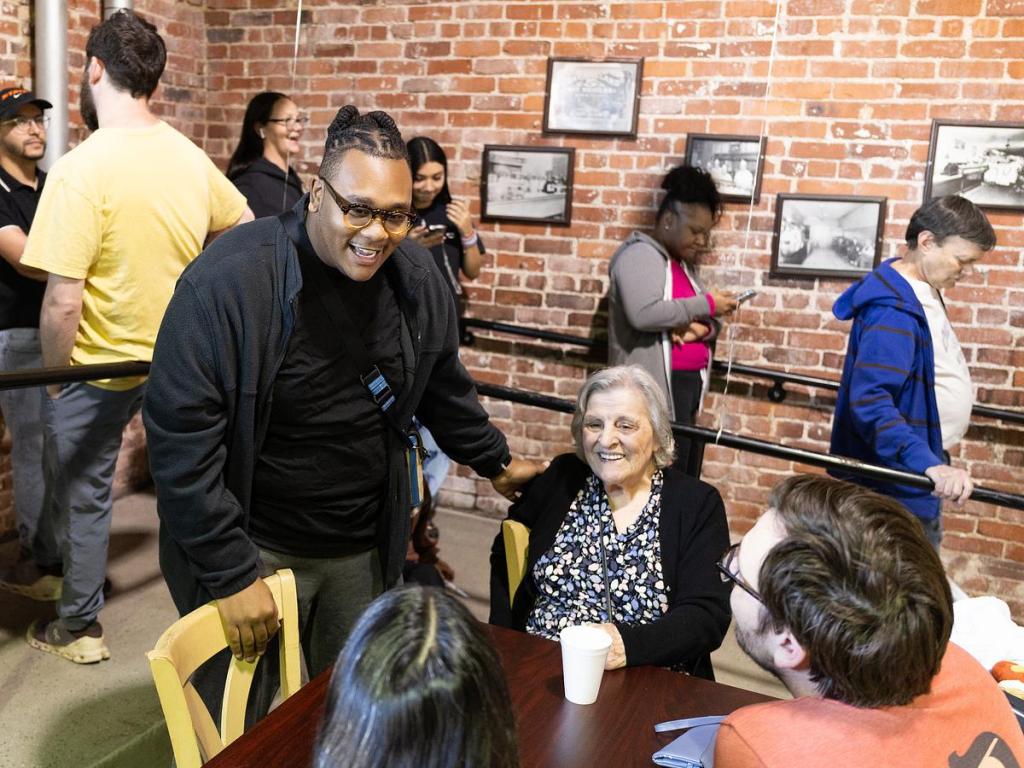Former Coney Island Hot Weiners employee Kevin Tolbert reminisces with the descendants of the original owners of the restaurant during its 100th birthday celebration Jan. 8, 2026.