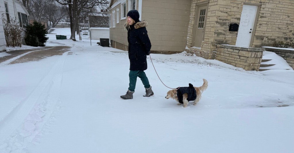 A woman walks her dog in the snow in midtown Tulsa Jan. 24, 2026.
