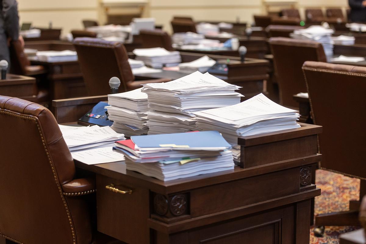 Bills are piled on a desk in the Oklahoma Senate Chamber in 2024. Credit: Abi Ruth Martin / Oklahoma Legislative Service Bureau