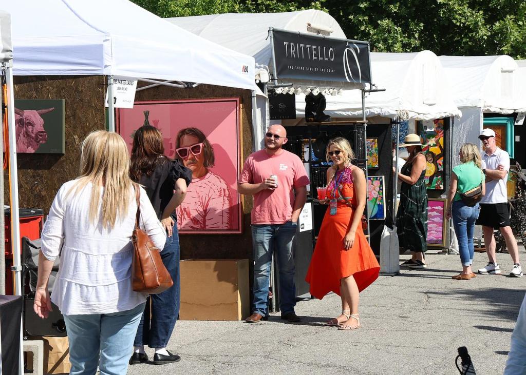 Mayfest attendees visit artist booths along North Boston Avenue in the Tulsa Arts District on May 9, 2025. 