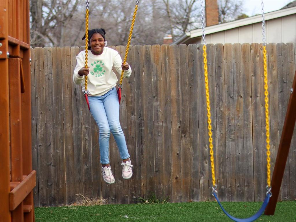 Maryah Johnson plays on the swin gset at Wykeyma Crockett’s home day care in east Tulsa, Jan. 16, 2026. Crockett says "God has been so good" and is proud of what she's come up with since an electrical fire scorched the home in 2024. 