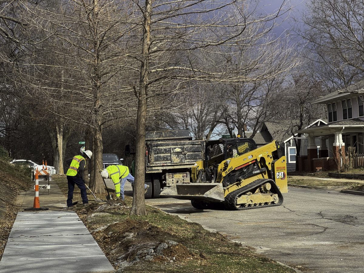Construction crews work on sidewalk