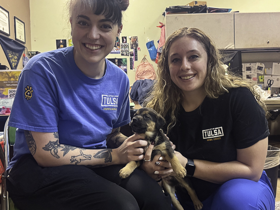 Veterinarian assistant Emma Lollis, left, and veterinarian clinic supervisor Taylor Roepke-Perez show off a rescued German Shepherd puppy at the Tulsa Animal Services shelter.