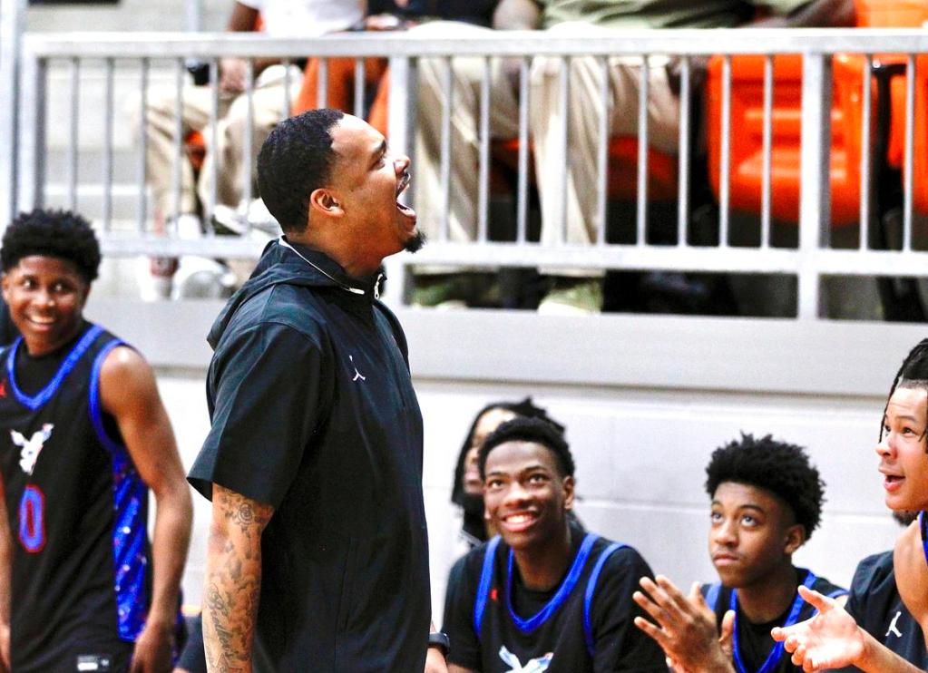 Millwood head basketball coach Dorrian Williams celebrates with fans in the final moments of his Falcons’ 71-56 win against Booker T. Washington on Saturday Jan. 17, 2026, at Nathan E. Harris Field House.