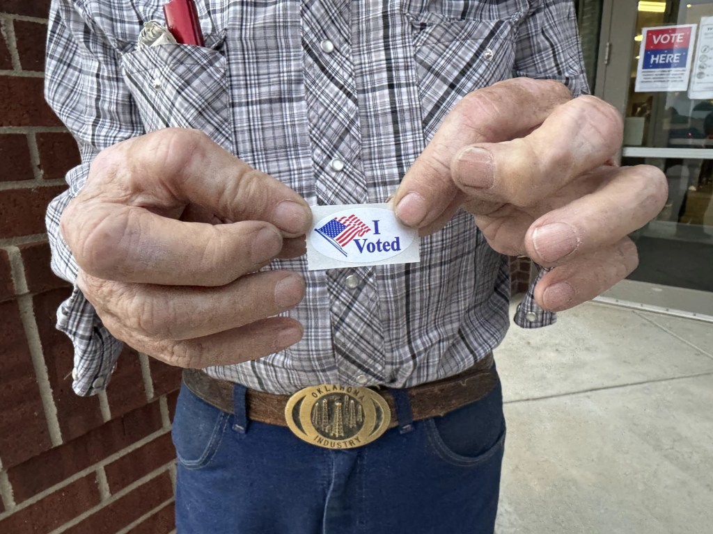A man shows off his "I voted" sticker in El Reno.