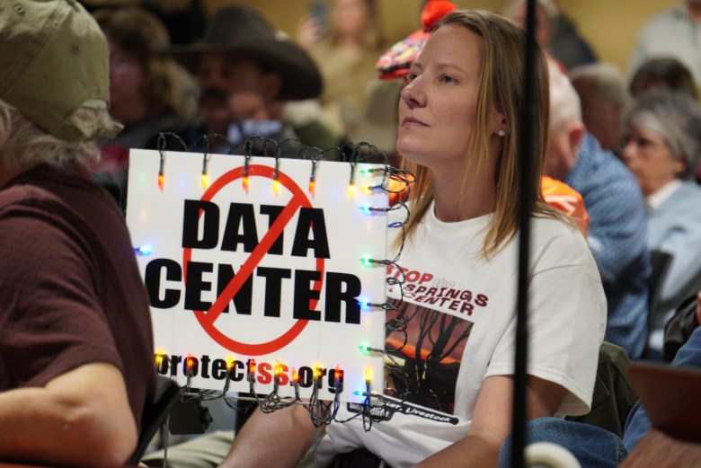 Residents hold signs opposing data center development at a Feb. 3, 2026, Sand Springs City Council meeting on Project Spring. City councilors approved a zoning change 6-1.
