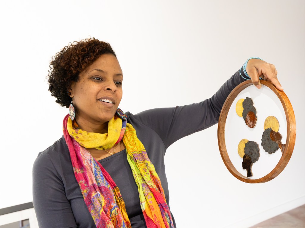 Co-curators Ebony Iman Dallas helps arrange artwork for “Permission to Breathe: A Black Woman’s Perspective on Living Life Unapologetically” at Positive Space Tulsa on Feb. 4, 2026.