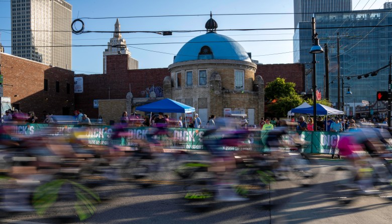 Tulsa Tough racers pass in front of the historic Blue Dome on opening night of the annual summer cycling event, Friday, June 6, 2025.