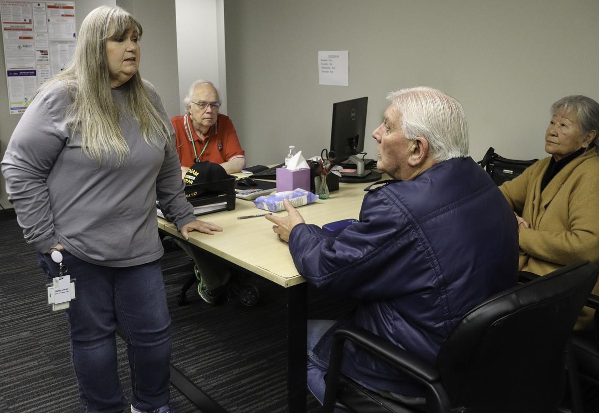 Kathy Jones, left, speaks with Ronald Trippe and Kwiran Lee Trippe about their tax return at LIFE Senior Services, Feb. 2, 2026. Jones oversees the program that provides free tax help for seniors who are at least 60 years old and making a total income of $69,000 or less.