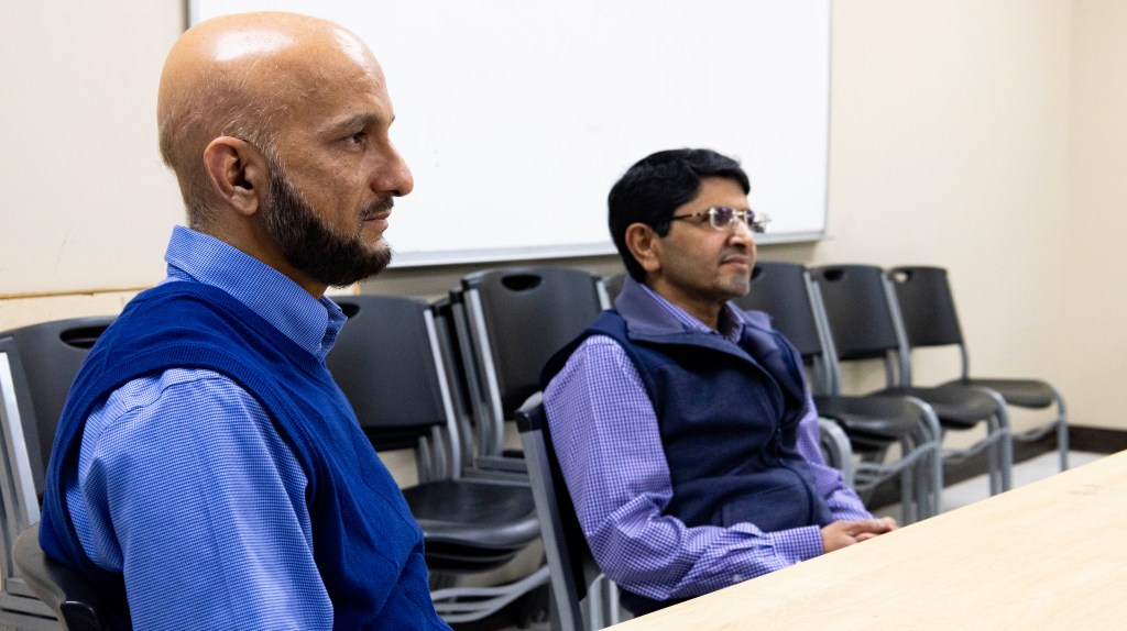 men sitting inside mosque