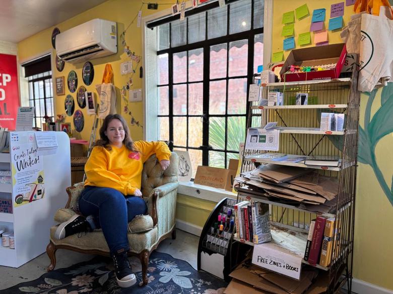 Melodie Coulter, co-owner of Tulsa's Meadow Market Books, sits inside her shop Feb. 20, 2026. The Cherry Street store offers free whistles to signal if immigration agents are near and zines with ideas for protesting ICE.