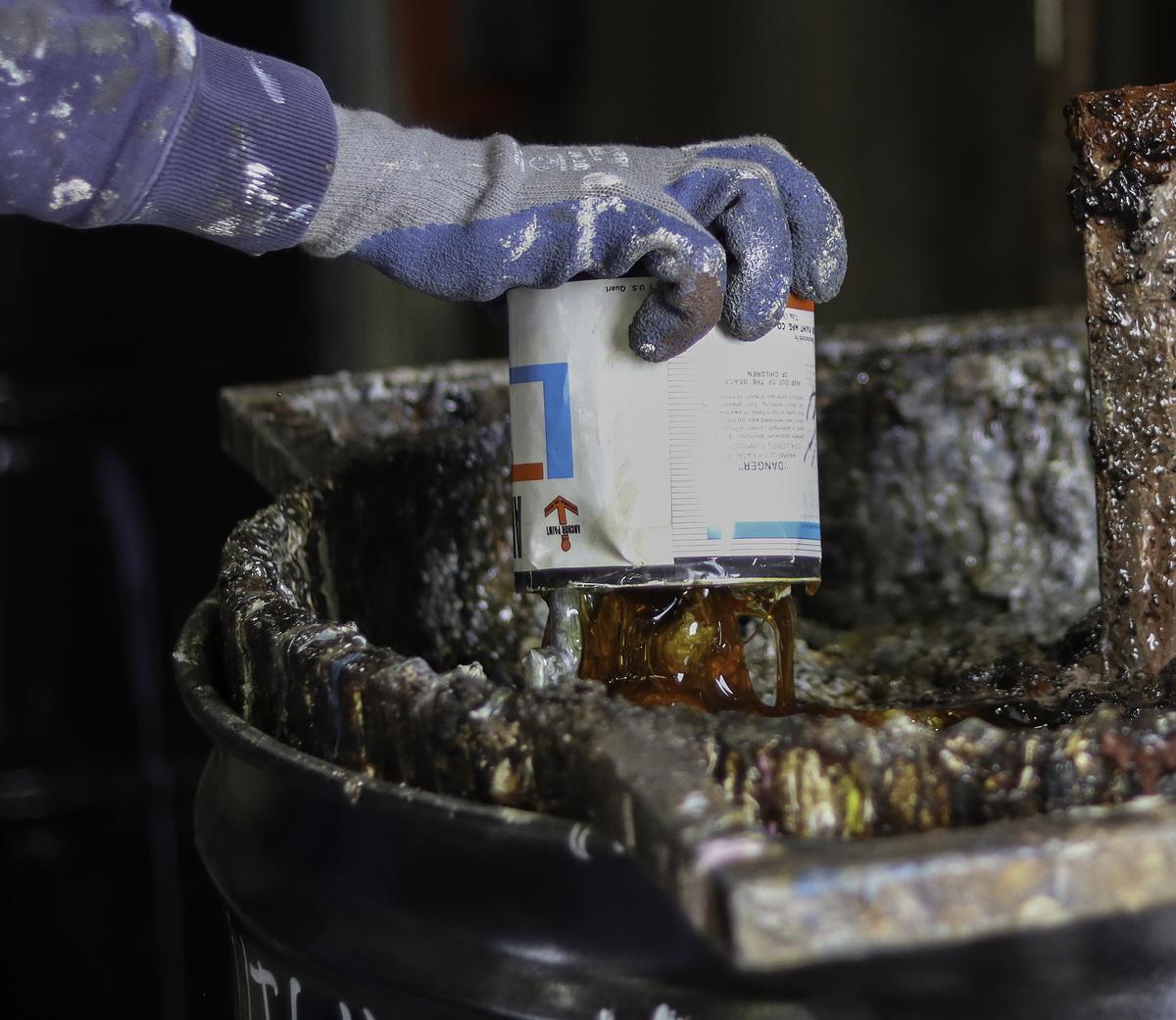 Mark Hodge dumps out old paint at the Tulsa Household Pollutant Collection Facility March 18, 2026. It's open to Tulsa residents from 8-11:30 a.m. and noon to 4:30 p.m. every Wednesday and Saturday.