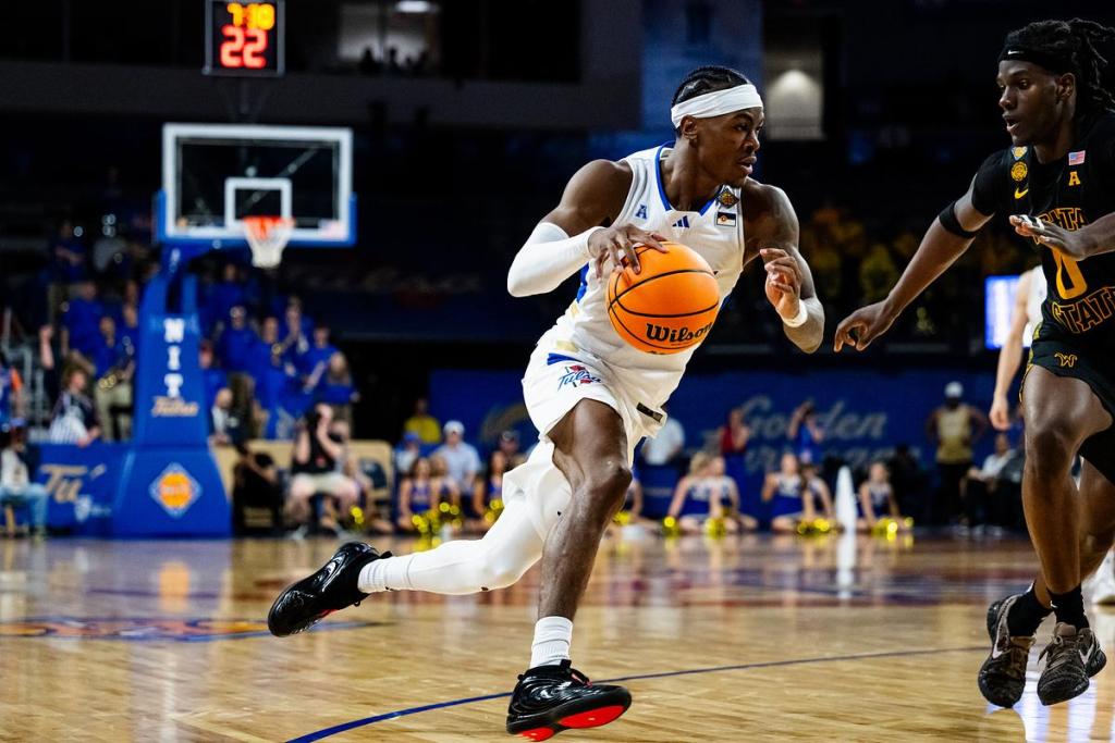 University of Tulsa’s Tylen Riley, left, dribbles the ball while being guarded by Wichita State’s Karon Boyd during their game at the Donald Reynold’s Center on Tuesday, March 24, 2026.