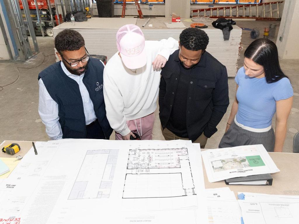 The Oasis Fresh Market team inside their new downtown store that is under construction inside ARCO Apartments, 119 E. 6th St., on March 2, 2026. 