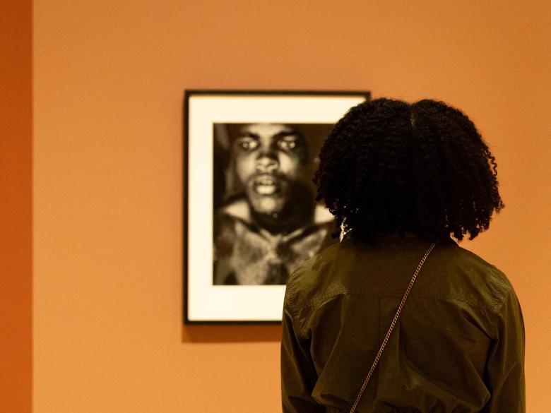 Attendees look at Gordon Parks photography during Dreamland Tulsa presents "A Journey Through Art, Music and Cinema" at Philbrook Museum of Art on Feb. 27, 2026.