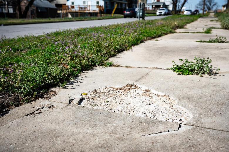 Sidewalk damage in west Tulsa is photographed on Friday, March 13, 2026.