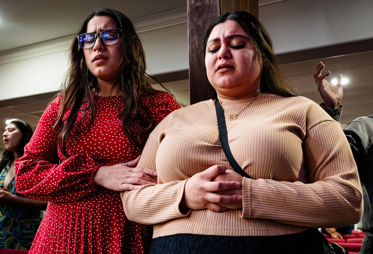 Daughters of Pastor Wulfrano Portillo comfort each other during worship at La Hermosa Church in Tulsa after their father was deported to Mexico