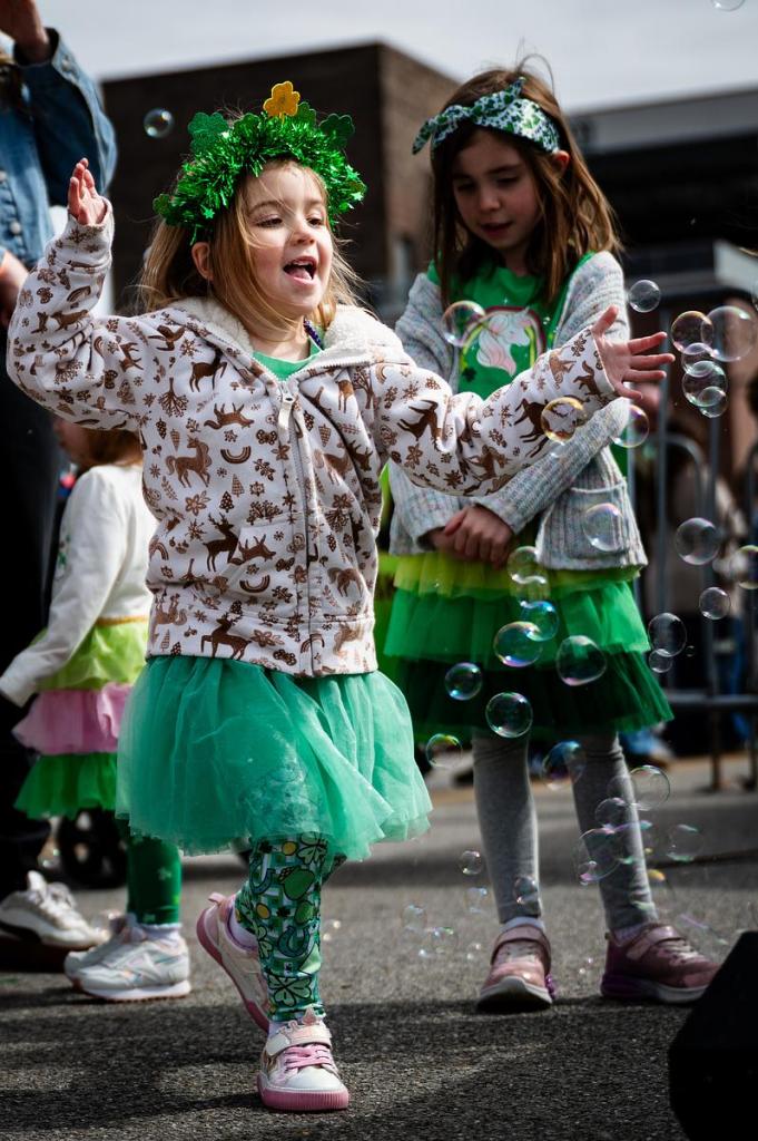 Lacy Kulik, age 4, plays in bubbles before getting her face painted during a St. Patrick’s Day celebration outside Killkenny's Irish Pub March 17, 2026. The block party included multiple bars, children's activities, music and more.