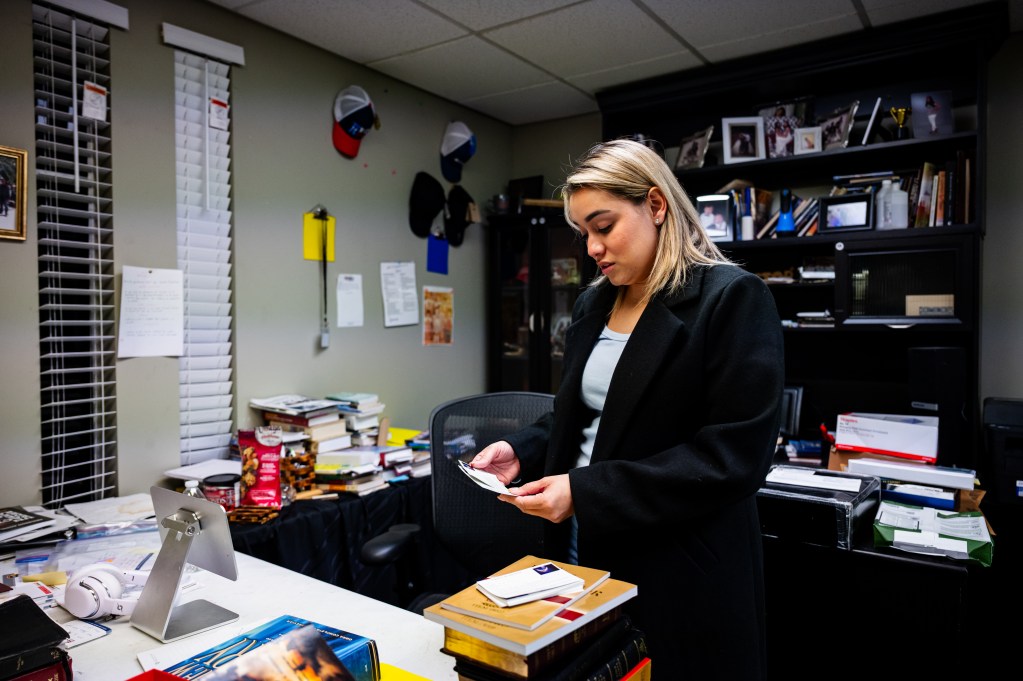 Tania Portillo holds welcome cards in her father's empty office at east Tulsa's La Hermosa Church March 18, 2026. Her father, Wulfrano Portillo, was a pastor there until he was recently deported to Mexico.
