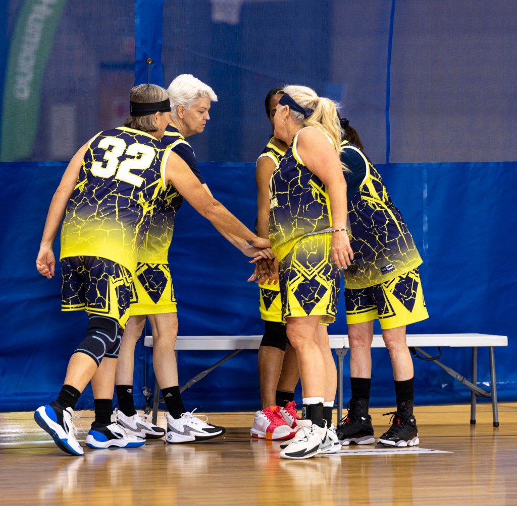 athletes compete in basketball game