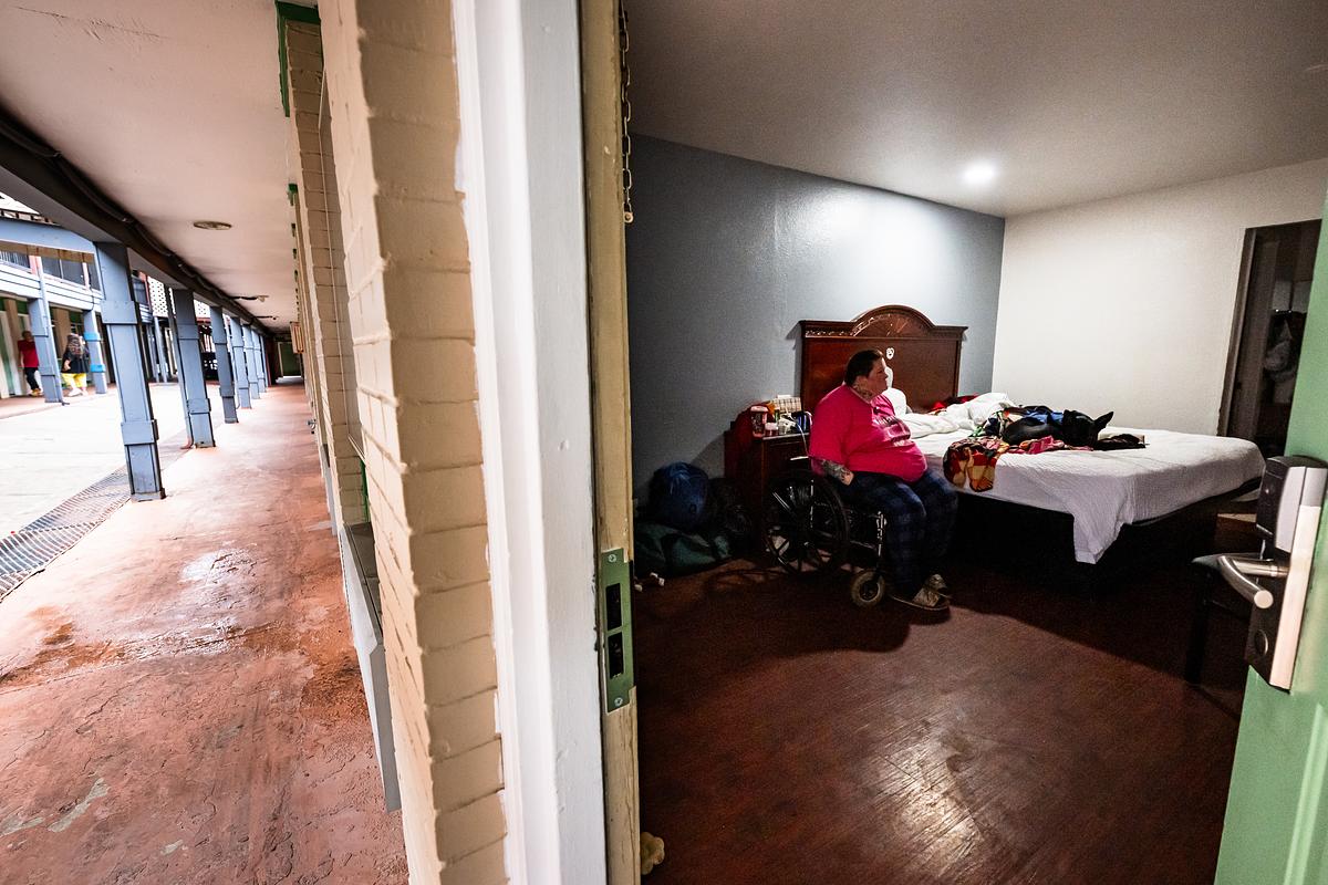Suzanne Stephens sits with her dog Sage in her motel room at Rest Inn & Suites March 10, 2026. Stephens has spent the past two years unhoused due to medical difficulties and recently moved into the motel with help from the Tulsa Day Center. Her animals are the most important thing to her.