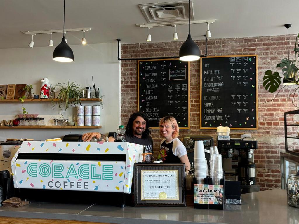 Co-owners Tyler Duncan and Lydia Duncan stand inside Coracle Coffee, located at 314 S. Cincinnati Ave. The coffee shop has placed signs against ICE and have Know Your Rights cards available for its customers. 