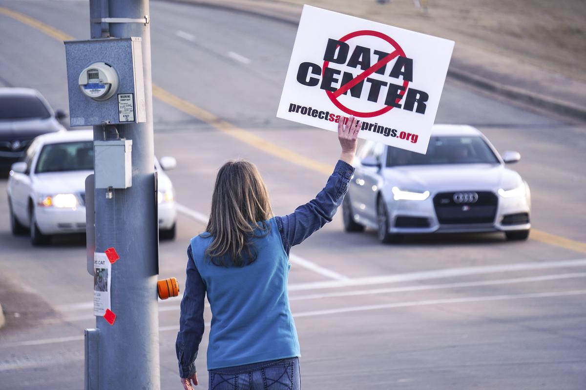 A protester opposes a data center proposal in Sand Springs before a Feb. 3, 2026, city council meeting. The project is one of many in the Tulsa region as developers rush to meet demand for the AI boom.