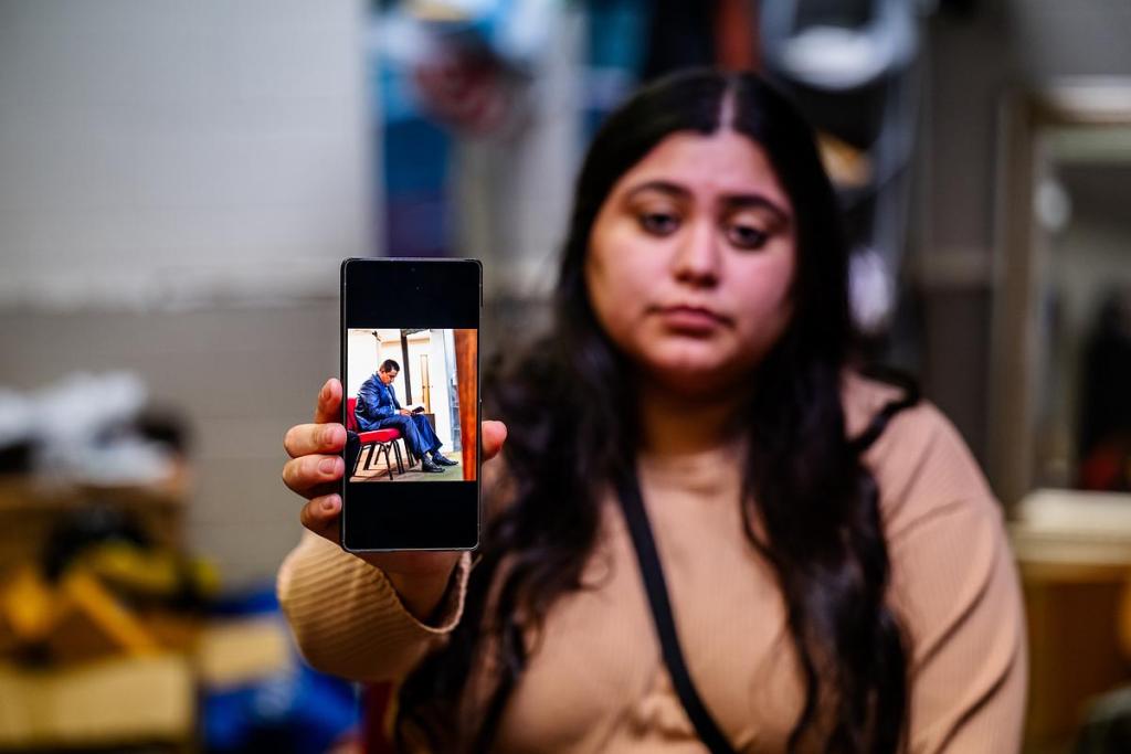 Kelsy Landaverde holds up a photo of her father Wulfrano Portillo before a March 18, 2026, worship service at La Hermosa Church. Portillo was a pastor there before he was deported to Mexico. His father started the church and passed down the responsibility of pastor down to his son.
