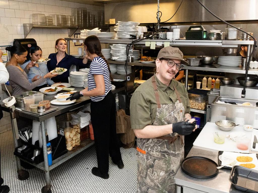 Austin Plumlee, executive chef at The Tavern, preps a Chef's Table course as servers collect dishes to take to diners March 13, 2026. 