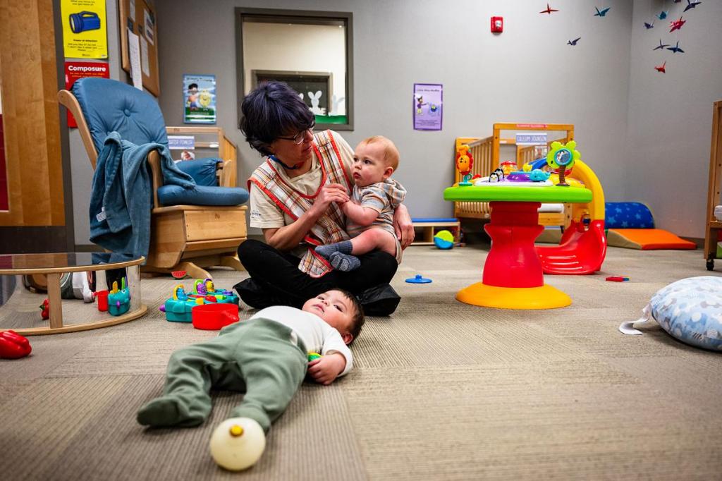 Josiah Iraheta, front, lays on the floor while Heidi Phelps holds Callum Johnson at the Crosstown Learning Center on Friday, April 10, 2026. 