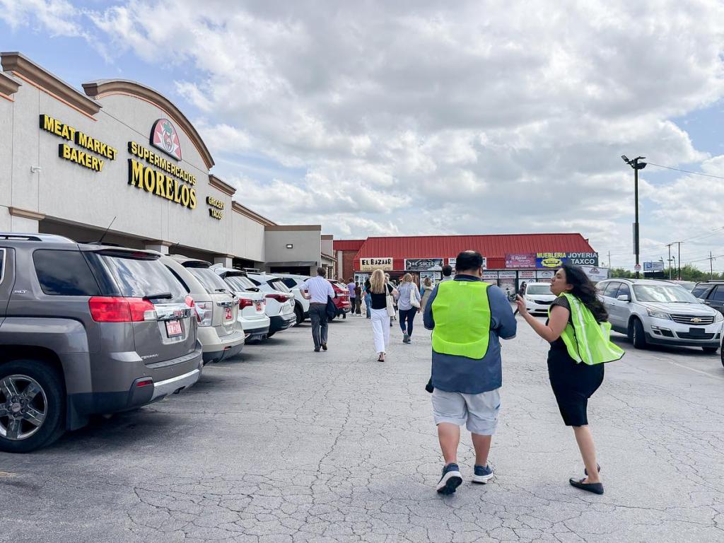 Organizers guide visitors to Supermercado Morelos during a mobile workshop highlighting the Tulsa Global District April 13, 2026, in east Tulsa.