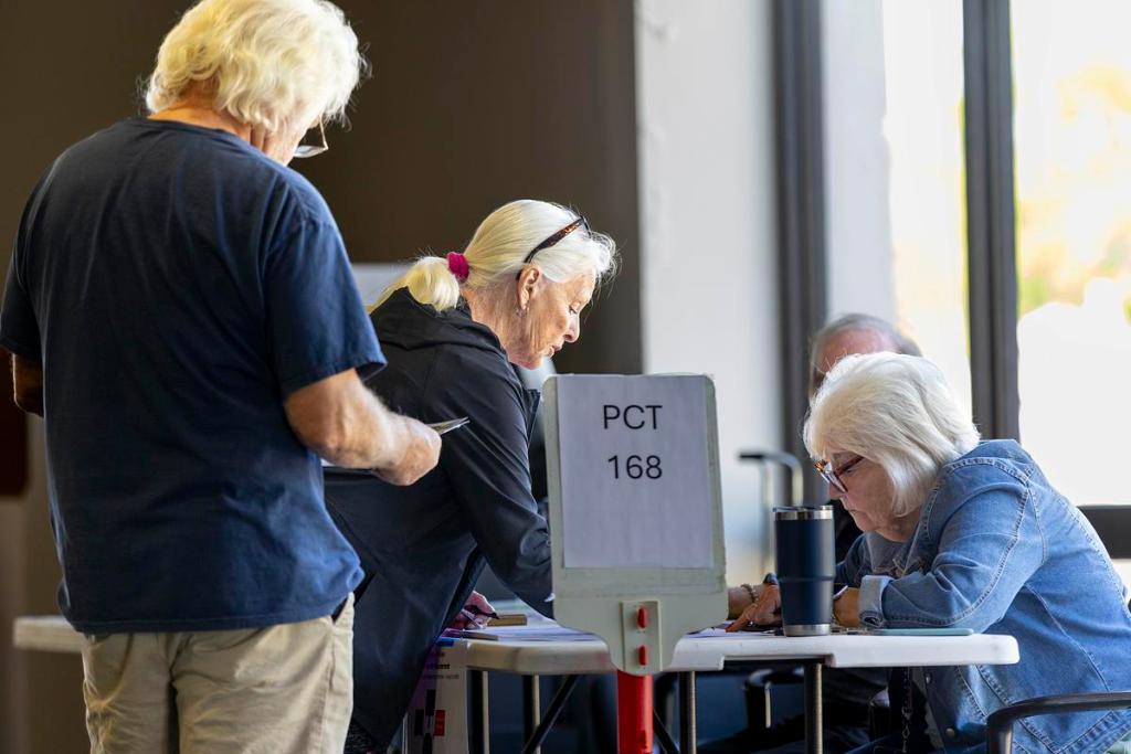 Voters check in to receive their ballots at Broken Arrow's Destiny Church on April 7, 2026. 